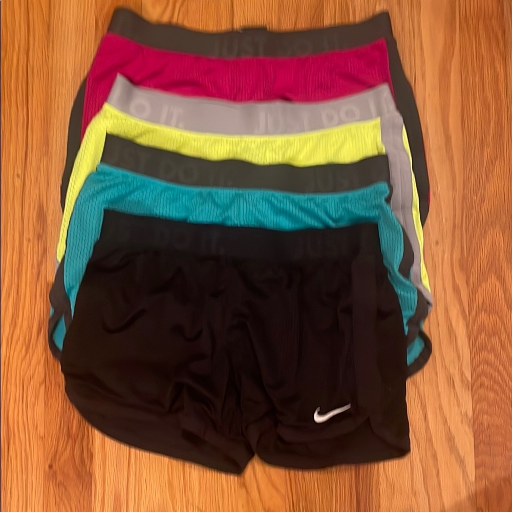 Four pair Nike Women's Athletic Shorts - Black, Pink, Gray, Yellow, Teal. Size S